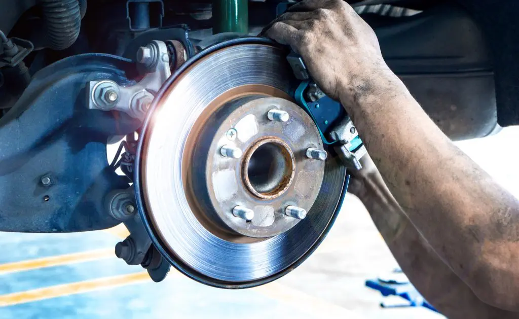 Replacing old brake pads on car