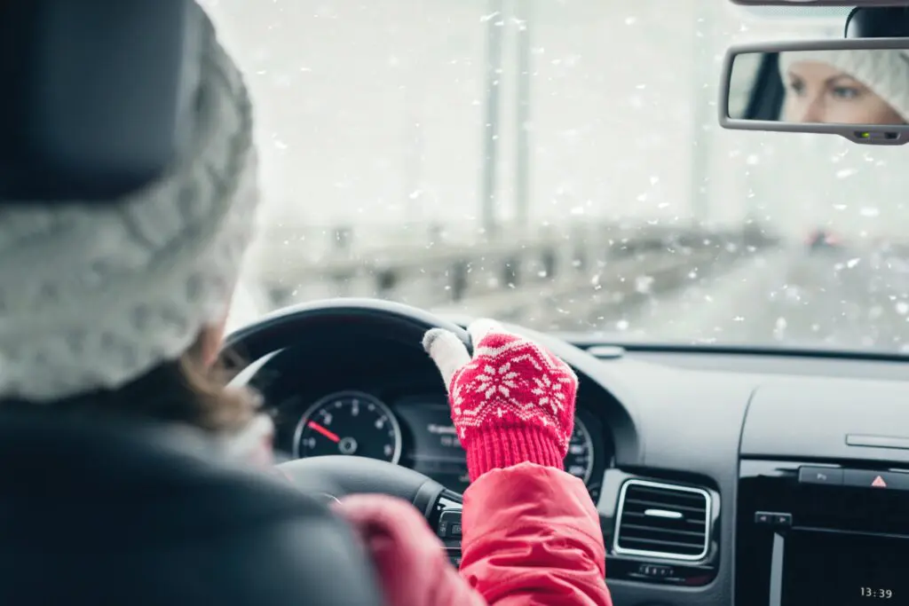 Woman in car driving on used winter tires