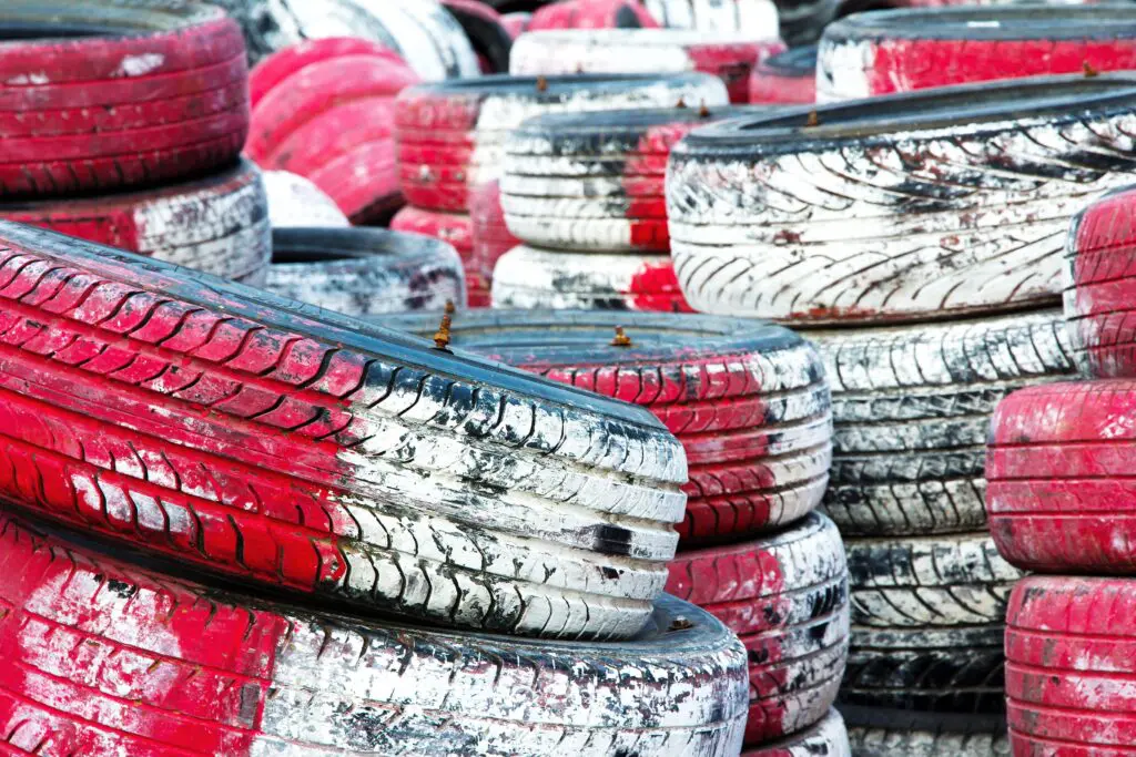 Piled used cars in red and white paint