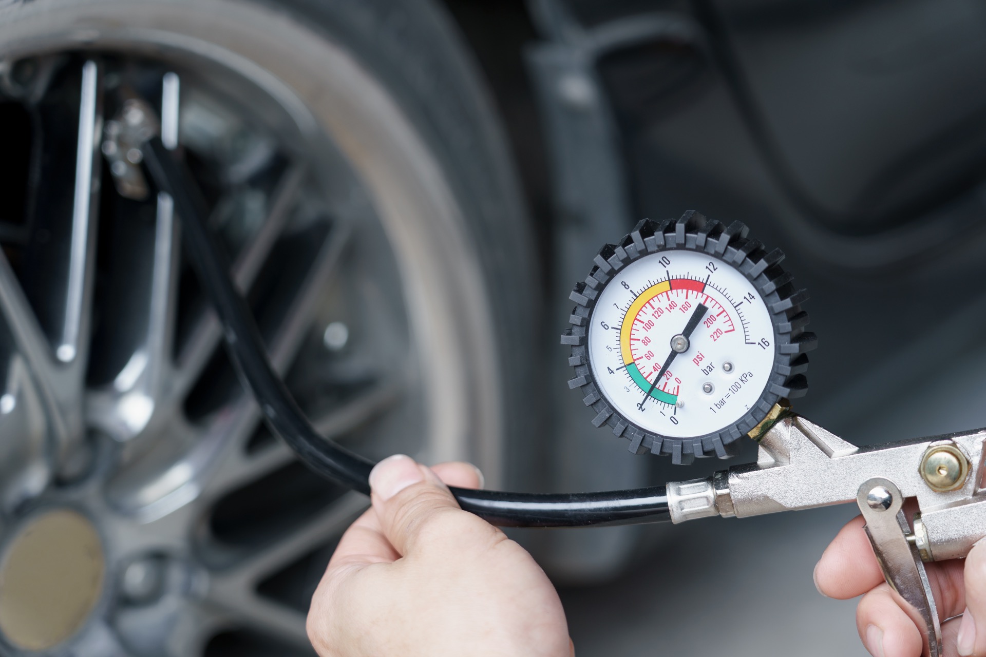 Checking tire pressure after inflating car tire