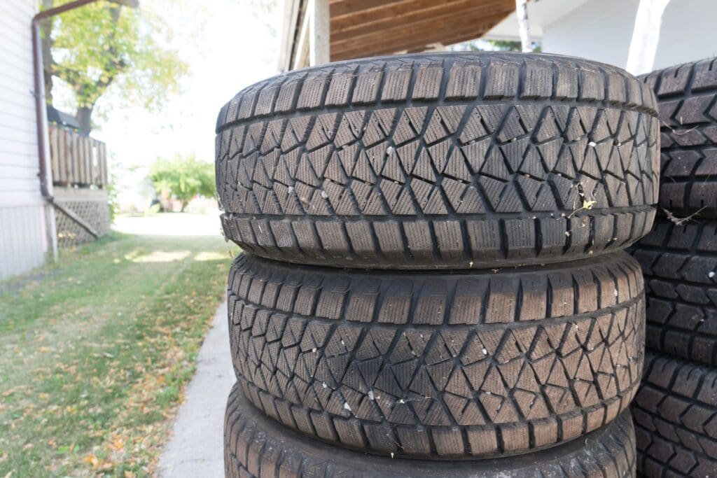 Stacked winter tires stored outdoors