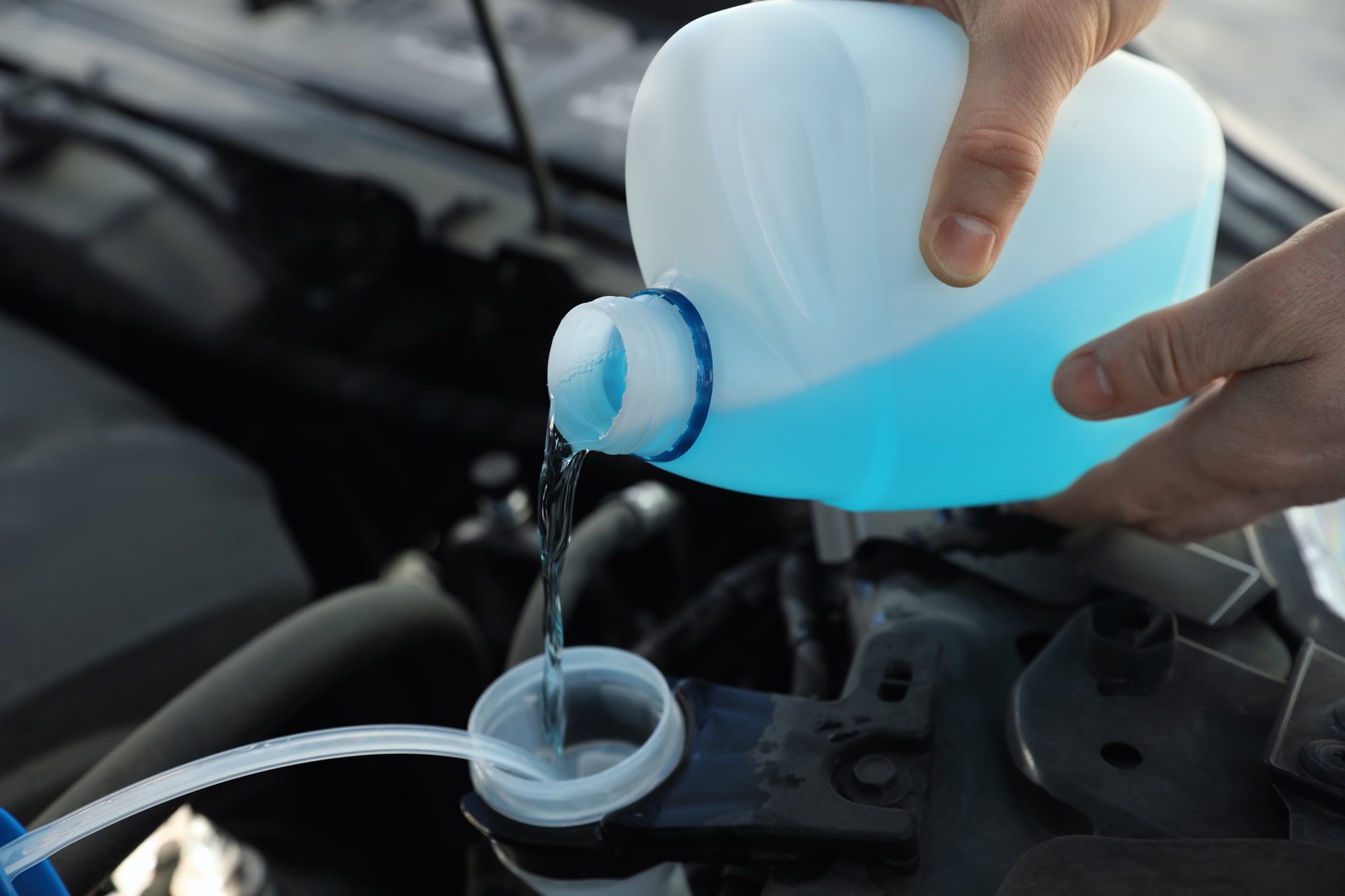 Pouring antifreeze into car