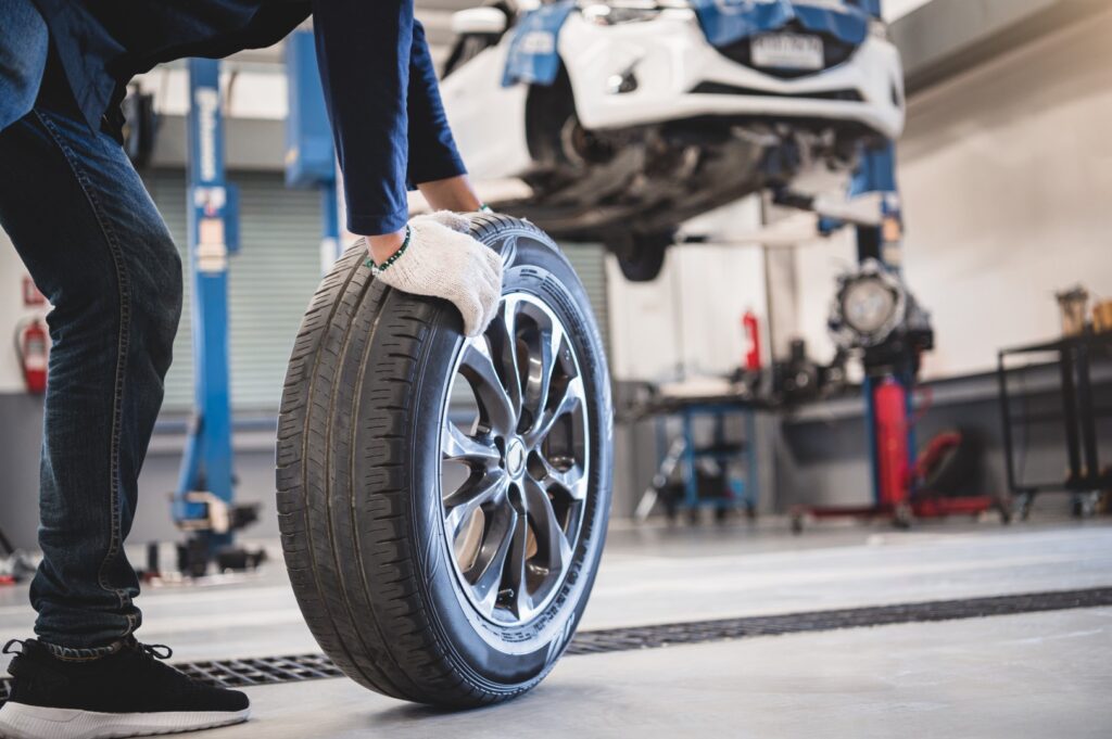 Auto mechanic changing vehicle tires