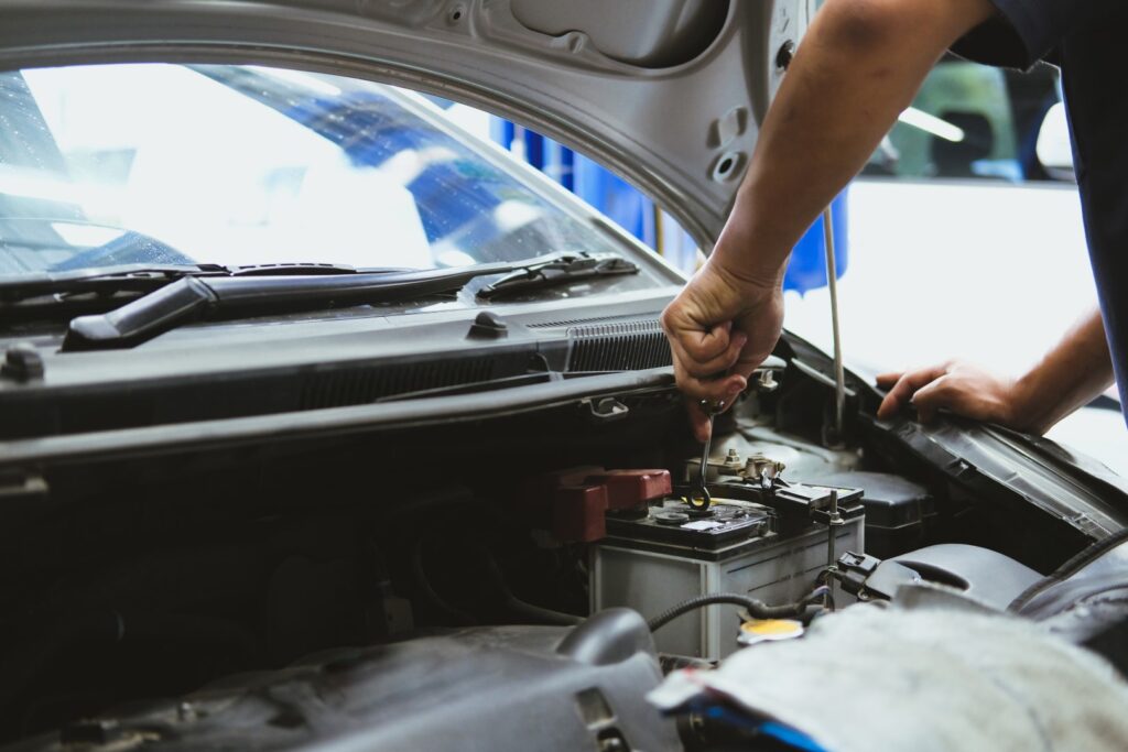Mechanic checking on car battery