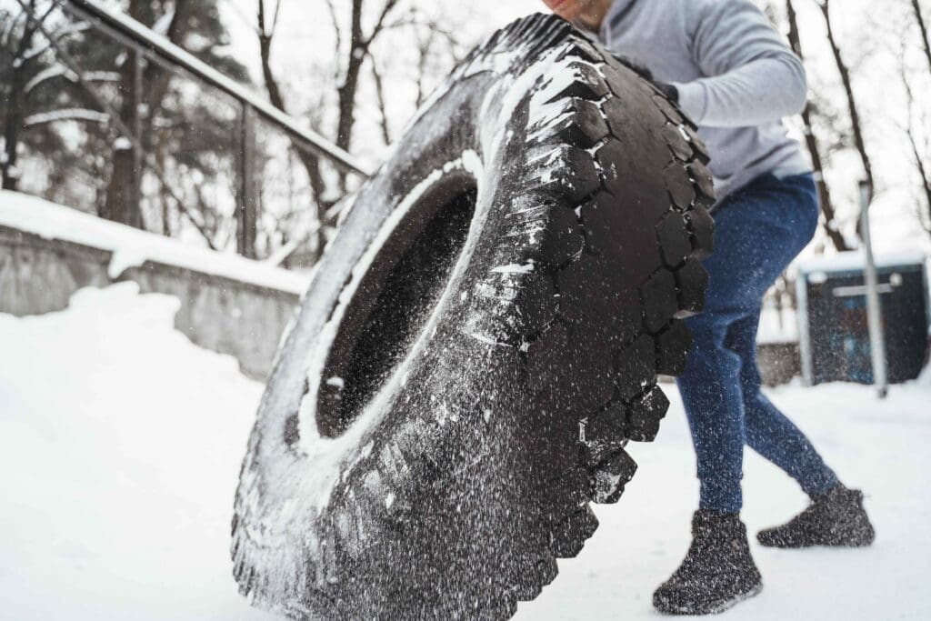 person flipping tire